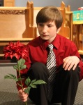 Alexandre contemplates how this flower grew so big.  No really... he is singing a selection from Shrek:  The Musical.
